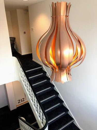 a staircase with a chandelier hanging from the ceiling at Hotel Skivehus in Skive