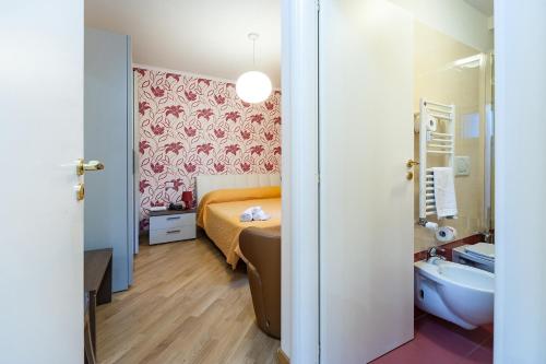 a bedroom with a bed and a sink and a tub at Nostalgia Romana in Rome