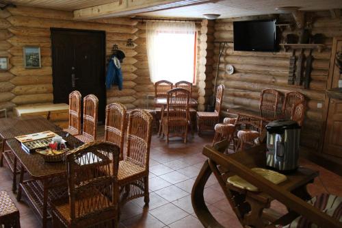 a dining room with tables and chairs in a log cabin at Green Style in Kyiv