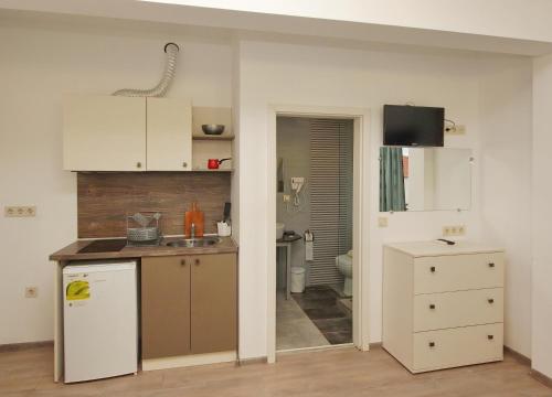 a small kitchen with a sink and a refrigerator at Villa Sithonia in Metamorfosi