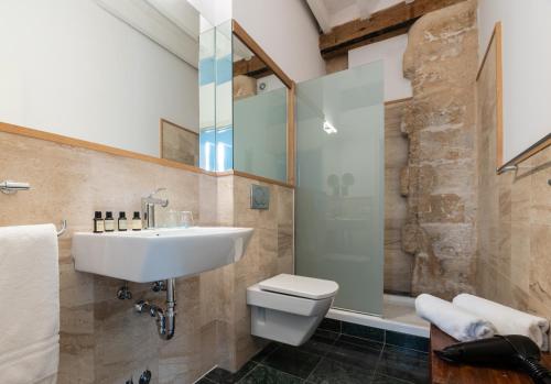 a bathroom with a sink, toilet and bathtub at Brondo Architect Hotel in Palma de Mallorca