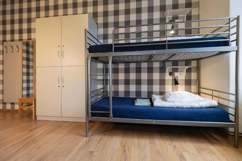 a bunk bed in a room with a blue bed at Atlantis Hostel in Kraków