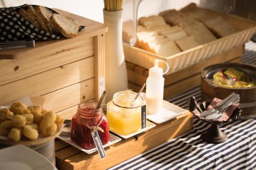 a table topped with a tray of bread and food at Siambeach Resort in Cha Am