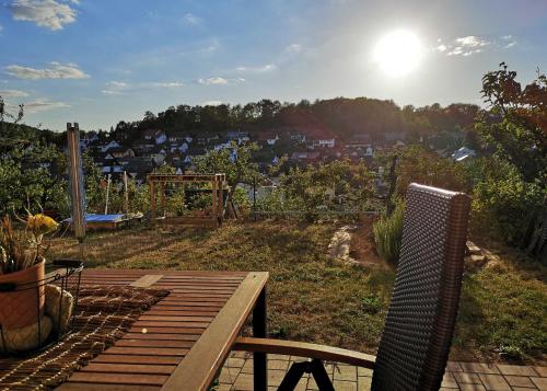 a deck with a bench and a view of a city at Ferienwohnung Im Paradies in Momlingen