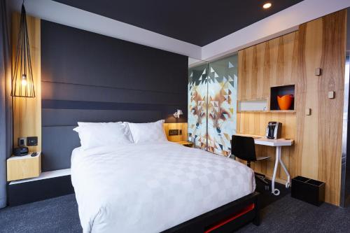 een hotelkamer met een groot bed en een bureau bij Alt Hotel Calgary East Village in Calgary