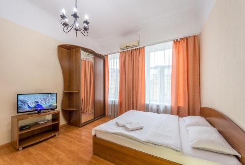 a bedroom with a bed and a television in it at Central Dayflat Apartments in Kyiv