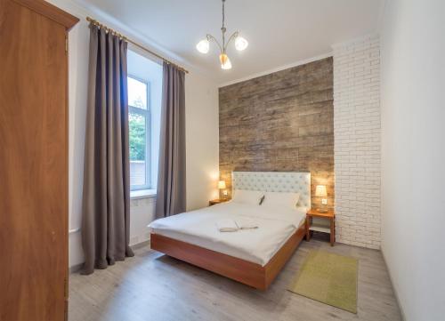 a bedroom with a bed and a brick wall at Central Dayflat Apartments in Kyiv