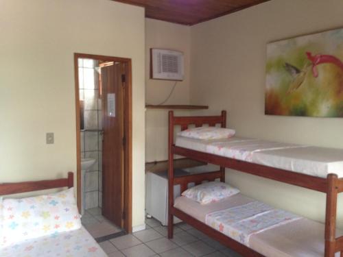 Camera con 2 letti a castello e una porta di Pousada Visual a Arraial d'Ajuda