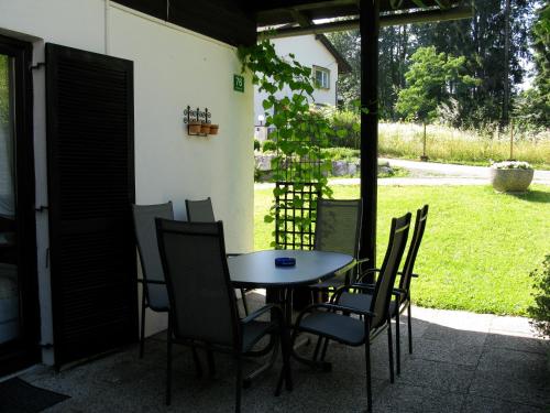 a table and chairs sitting on a patio at Ferienbungalow Weber in Velden am Wörthersee