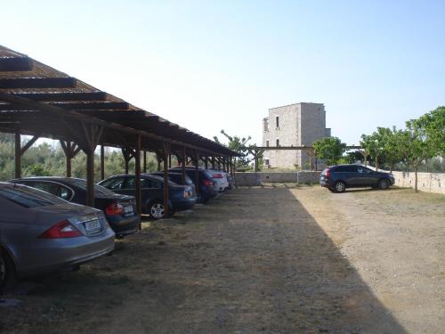 a row of cars parked in a parking lot at Castello Antico Hotel in Gythio