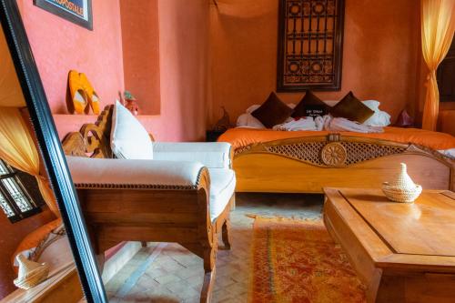 a hotel room with two beds and a table at Dar Sohane in Marrakesh