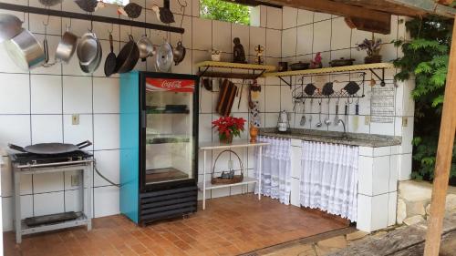 a kitchen with a counter with pots and pans at Estância das Angolas - Inhotim in Brumadinho