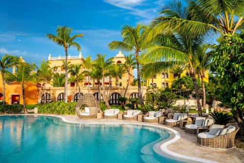 a resort with a swimming pool and palm trees at Sanctuary Cap Cana, a Luxury Collection Resort, Dominican Republic, Adult All-Inclusive in Punta Cana