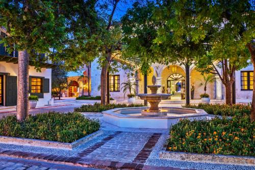 a fountain in the middle of a courtyard with trees at Sanctuary Cap Cana, a Luxury Collection Resort, Dominican Republic, Adult All-Inclusive in Punta Cana