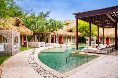 a swimming pool in the middle of a resort at Sanctuary Cap Cana, a Luxury Collection Resort, Dominican Republic, Adult All-Inclusive in Punta Cana