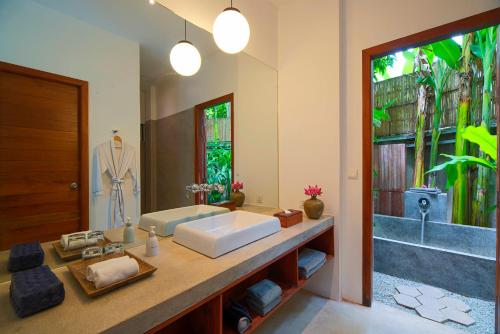 a bathroom with a sink and a large mirror at Silver Urban in Siem Reap