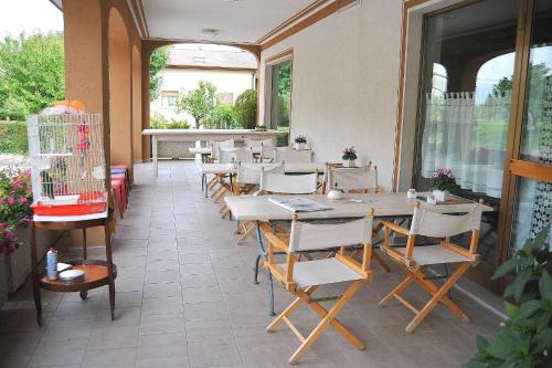 a restaurant with a table and chairs and a window at Locanda da Cidalie in Ragogna
