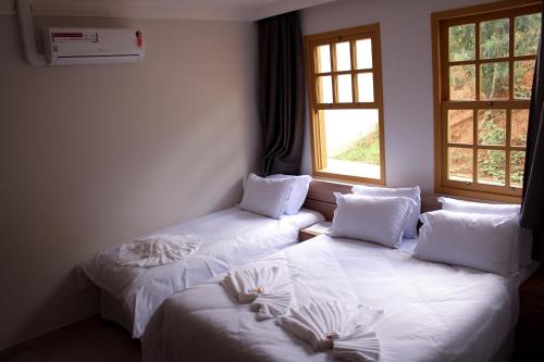Кровать или кровати в номере Pousada Primaz de Minas