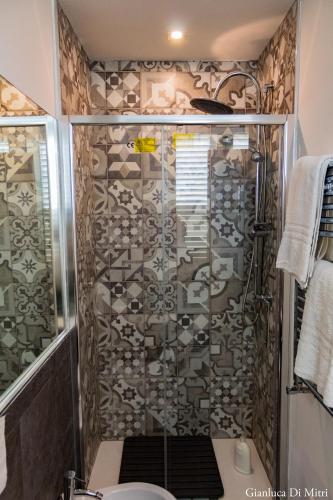 a bathroom with a shower with a toilet at Mongibello Palace B&B in Mondello