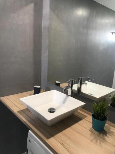 a bathroom with a white sink and a mirror at Monte Rojo San Agustin in San Agustin