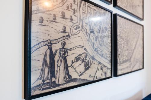 a group of framed drawings on a wall at Les Précieuses Suites & Spa I in Avignon