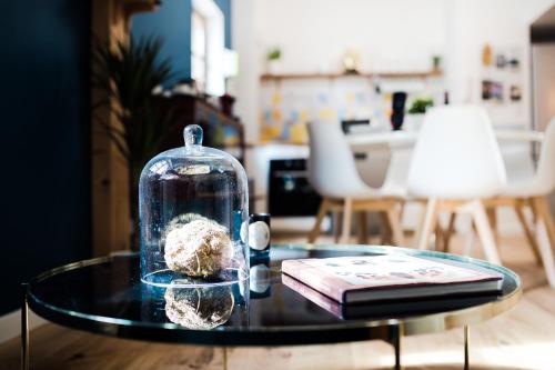 a glass table with a glass container on top of it at Les Précieuses Suites & Spa I in Avignon