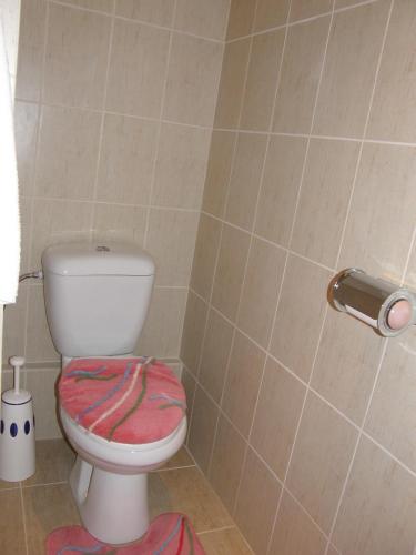 a bathroom with a toilet with a towel on it at Apartments Meixner in Mariánské Lázně