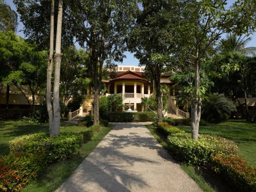 a house with a pathway in front of it at Dusit Thani Hua Hin in Cha Am