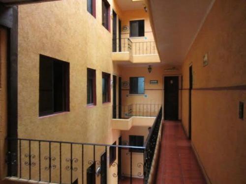 an empty hallway of a building with a balcony at Hotel Recreo in Mexico City