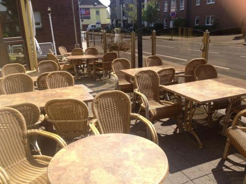 a bunch of tables and chairs sitting on a street at Hotel Flora in Dormagen