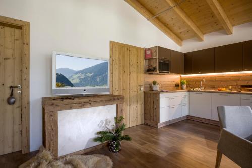 a large kitchen with a large window in a room at Aparthotel Gallahaus in Zell am Ziller