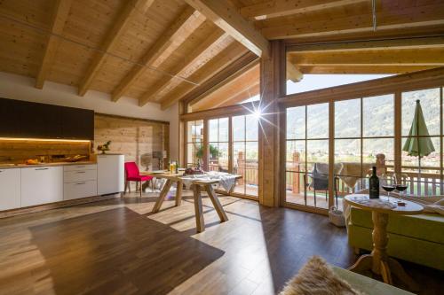 a kitchen and dining room with a large window at Aparthotel Gallahaus in Zell am Ziller