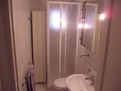 a bathroom with a shower and a toilet and a sink at Casa Iaia in Genova