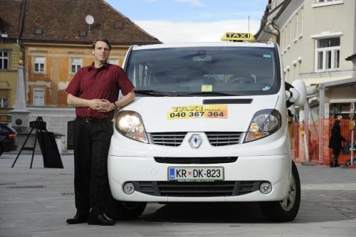 a man standing in front of a white van at Guesthouse Stari Mayr in Kranj