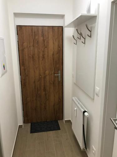a hallway with a wooden door in a house at Apartmán B3 Biela Púť - Jasná in Belá