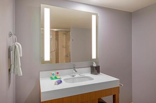 a bathroom with a sink and a large mirror at Hyatt Place Keystone - Dillon in Keystone
