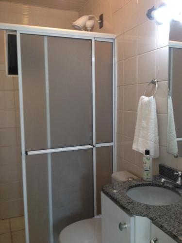 a bathroom with a shower and a sink at Apartamento Vila do Sol in Blumenau