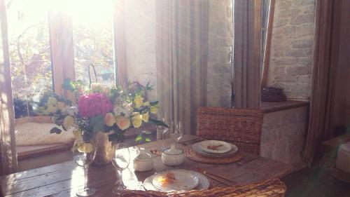 a room with a table with a vase of flowers at Overture Studio in Kamianets-Podilskyi