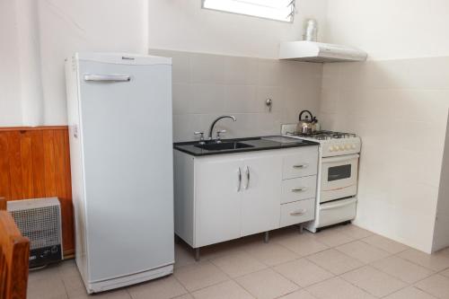 a small kitchen with a sink and a refrigerator at ALOJAMIENTO SARMIENTO in General Alvear
