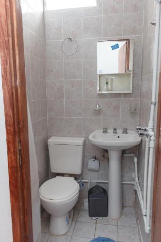 a bathroom with a toilet and a sink at ALOJAMIENTO SARMIENTO in General Alvear