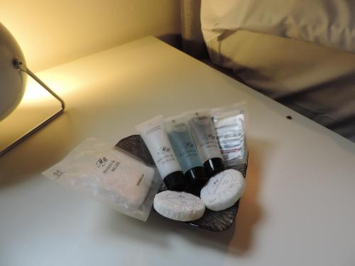 a table with some towels and a lamp on it at 5 Bed Camberley Airport Accommodation in Camberley