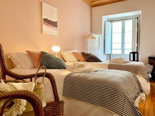 a bedroom with two beds and a window at Apartments Center Castelo de São Jorge in Lisbon