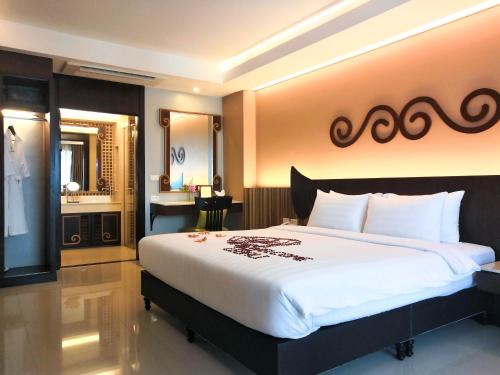 En eller flere senge i et værelse på Le Bali Resort & Spa