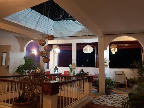 a house with a balcony with potted plants and lights at Dar Zerhoune in Moulay Idriss Zerhoun