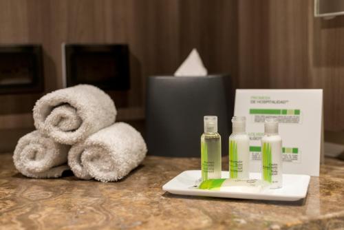 a hotel room counter with towels and a bottle of soap at Holiday Inn - Lima Airport by IHG in Lima