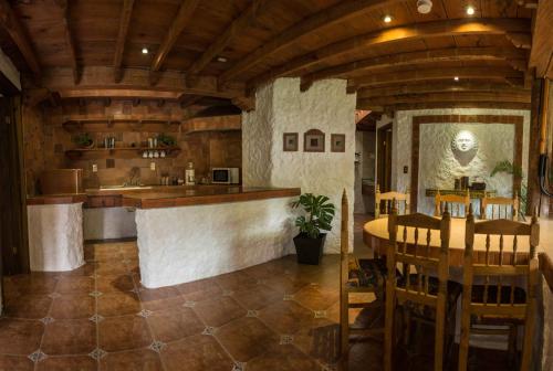 a kitchen with a bar and a table and chairs at Hotel Bosques del Sol Suites in San Cristóbal de Las Casas