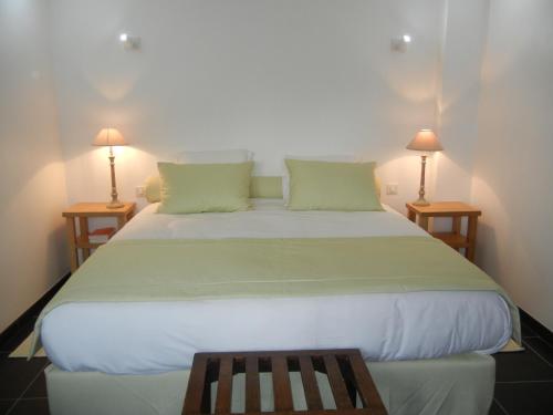 a bedroom with a large white bed with two lamps at Château De Cocove in Recques-sur-Hem
