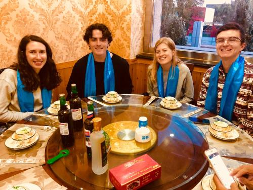 a group of people sitting around a table at Lemongo Youth Hostel Hohhot in Hohhot