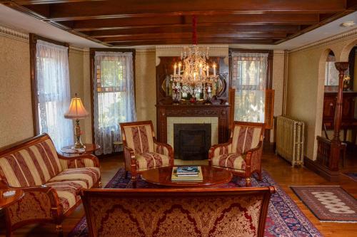 a living room with a table and chairs and a chandelier at The Towers Bed & Breakfast in Milford