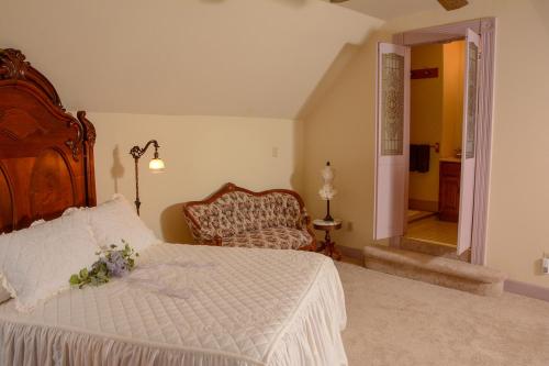 a bedroom with a large bed and a chair at The Towers Bed & Breakfast in Milford